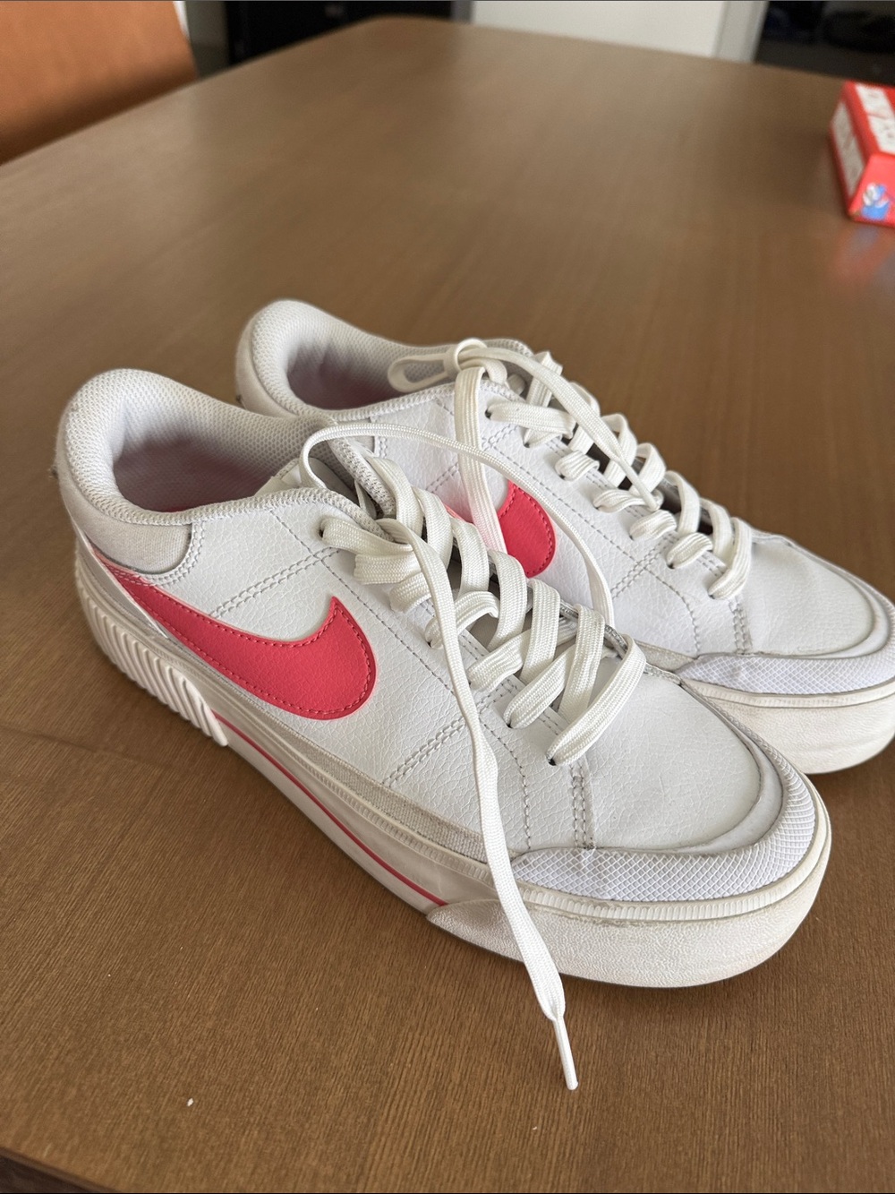 Nike Women’s White Sneakers with Pink Swoosh Accent